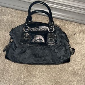 Coach handbag. Black in color. Bag has wonderful silver studs.
